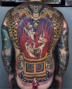 the back of a man with tattoos on his body