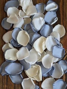 several pieces of white and blue fabric on a wooden surface