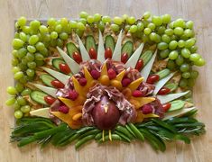 an arrangement of fruits and vegetables arranged in the shape of a flower