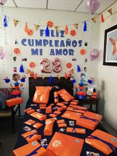 an orange and blue birthday party with decorations