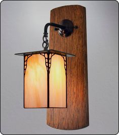 a wooden wall light with two lights on it