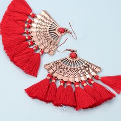 These unique bohemian fan tassel earrings feature red fan tassel on metal fan charm. Add these unique boho fan tassel dangle drop statement earrings to your everyday fashion earrings collection or as gift for your love one. Materials: mettal, cotton tasselFinish: rose gold color Jewelry Care: See more information about how to care for your jewelry here. Shipping Policy: Orders will be shipped within 1-3 business days. Economy shipping will take 7-14 days to arrive and standard shipping is 1- 4 d Metal Tassel Fringe Drop Earrings, Bohemian Metal Tassel Earrings For Party, Elegant Red Tassel Earrings For Summer, Tassel Metal Earrings For Festival, Metal Tassel Earrings For Festival, Red Metal Earrings For Summer, Red Fringe Tassel Earrings For Summer, Red Bohemian Metal Chandelier Earrings, Bohemian Red Metal Chandelier Earrings