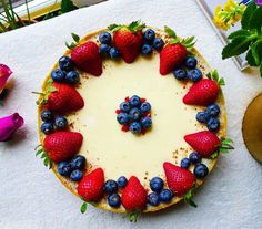 a cake with strawberries and blueberries on it