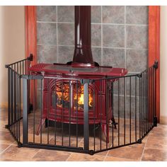 a red stove sitting inside of a metal cage