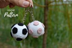 two crocheted soccer balls hanging from a key chain