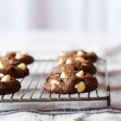 cookies with white chocolate chips are cooling on a rack