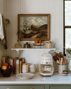 the kitchen counter is cluttered with dishes and utensils