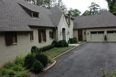 a large house with two car garages in the driveway