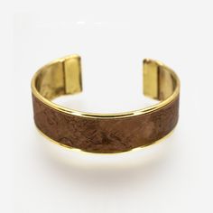 "Cork Bracelet, Portuguese jewelry, Natural Cork Bracelet, Cork Leather, Portuguese Cork, Camouflage Cuff, Jewelry, Eco-Friendly Jewelry □ Length is 6 inches from end to end □ Choose from 3/4-inch, 1-inch & 1.5-inch widths □ Materials: Portuguese Cork, Brass □ Color: Gilded Gold Brass □ Pattern: Cocoa / Metallic Brown DESCRIPTION Flexible brass channel cuff handmade with genuine Portuguese cork. Made of flexible, lightweight tarnish-proof brass & adjustable to most wrist sizes. Photos ar Adjustable Gold Leather Cuff Bracelet, Adjustable Brass Bracelets For Formal Occasions, Gold Leather Cuff Bracelet, Adjustable Brass Bangle For Formal Occasions, Formal Adjustable Brass Bangle, Nickel-free Brown Bracelets As Gift, Nickel-free Brown Bracelets For Gifts, Elegant Brown Cuff Leather Bracelet, Elegant Adjustable Brown Cuff Bracelet