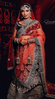 a woman in a red and silver bridal outfit