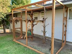 an outdoor area with a fence, tree and bird feeder