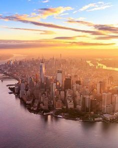 an aerial view of new york city and the hudson river at sunset, from above