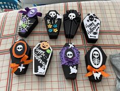 halloween treat boxes are decorated with black and white paper, orange ribbon, and skeleton decorations