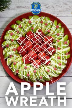 a red plate topped with apples covered in white icing and strawberries on top of it