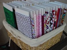 a basket filled with lots of books on top of a table