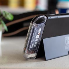 an external hard drive attached to the back of a laptop computer sitting on a table