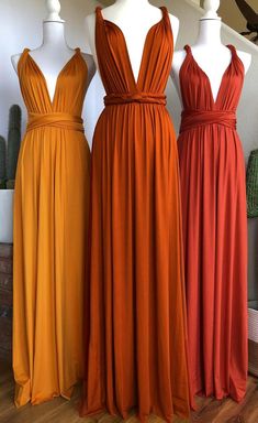 three dresses on mannequins in different colors