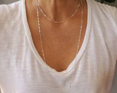 "This dainty minimalist necklace set is so simple and elegant. You can wear them together or separately. The 44\" long sparkly chain can be worn long or double or triple layered for completely different looks! The tiny hammered disk necklace is the perfect accent to add no matter how you wrap the long chain. The hammered disk necklace is shown in gold in 20\" length and silver in 17\" length. All items are handmade with high quality gold fill or sterling silver materials so they won't tarnish or Minimalist Double Strand Layered Necklace, White Minimalist Layered Necklace With Adjustable Chain, Minimalist Adjustable Layered Necklace For Everyday, Necklaces Layering, Disk Necklace, Two Necklaces, Double Necklace, Layering Necklaces, Disc Necklace