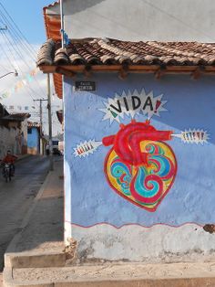 a mural on the side of a building with a heart painted on it's side