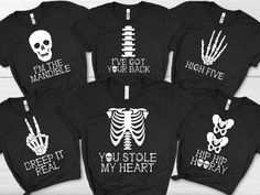 Family Skeleton Costume, Black Halloween T-Shirt, Matching Group / Work / Office Outfit, Adult / Teen / Youth Size Tee, Unisex Fall Clothing A classic cotton tee made with an extremely soft preshrunk cotton. The graphic is digitally printed on top of the cotton to produce a vivid garment with a soft hand feel. Adult Unisex Size Guide: Unsure what size to order? Always order a size up if unsure. We pride ourselves in offering a wide array of product types and size runs in order to be inclusive to the widest array of body types. Ultimately sizing can be a very subjective thing and for that reason it's important that the sizing instructions are followed carefully. Please read entire listing description before purchasing your item. (XS) W= 17.5" L= 27" (S) W= 19" L= 28" (M) W= 20.5" L= 29" (L) Stretch Halloween T-shirt With Graphic Print, Halloween Stretch T-shirt With Graphic Print, Halloween Stretch Tops With Letter Print, Black Stretch T-shirt For Halloween, Black Horror Tops With Skull Print, Black Horror Screen Print Tops, Black Band Merch Tops For Halloween, Black Band Merch Top For Halloween, Spooky Black Pre-shrunk Tops