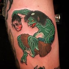 a tattoo with an image of a demon and a demon on it's leg