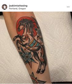 a person with a horse tattoo on their arm