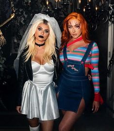 two women dressed in costumes standing next to each other with makeup on their faces and hands