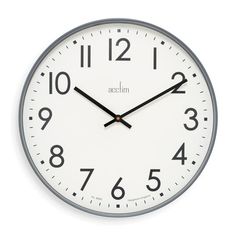 a white clock with black hands and numbers on the face is shown against a white background