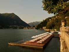 an outdoor dining area on the edge of a lake