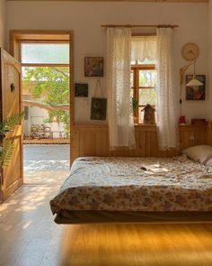 a bed sitting in a bedroom next to two windows