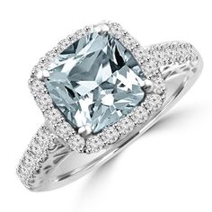 a fancy ring with an aqua blue diamond in the center and pave diamonds surrounding it