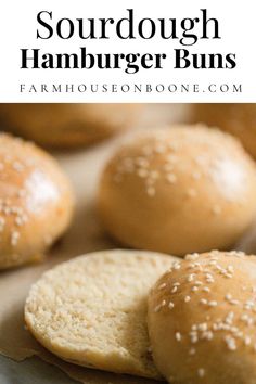 homemade sourdough hamburger buns with sesame seeds on top and in the background