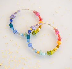 Set of Rainbow beaded hoop earrings DETAILS: 45mm hoops Gold filled hoops Earring post are lead and nickel free.  *Beads may vary slightly. PACKING AND SHIPPING: Please do not use the notes section of your order to relay time sensitive information (such as needing an address change). If you need to relay information regarding shipping, please message us directly. Requesting an arrival date in the notes section of your order does not guarantee it will arrive by that day, but we'll do our best! Pl Nickel-free Hoop Earrings With Heishi Beads, Gift Hoop Earrings With Heishi Beads, Small Hoop Heishi Beads Earrings For Gift, Heishi Beads Small Hoop Earrings As Gift, Small Hoop Heishi Beaded Earrings As Gift, Gay Pride Jewelry, Pride Earrings, Pride Jewelry, Pride Jewellery