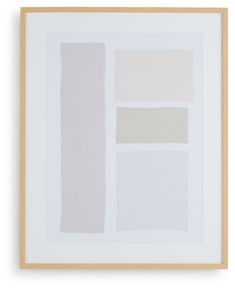 a white and beige painting hanging on a wall