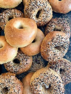 a bunch of bagels that are sitting on a counter top with sprinkles