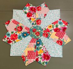 a multicolored patchwork flower design on a table