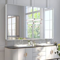 a bathroom with two sinks and a large mirror on the wall above it is shown