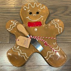 a cookie shaped like a ginger with a knife in it