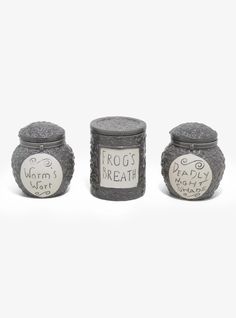 three jars with writing on them sitting next to each other