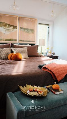 a bed sitting in a bedroom next to a table with fruit on top of it