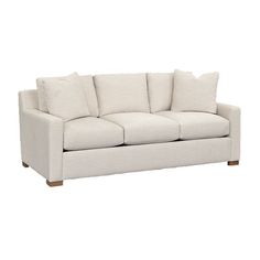 a white couch with pillows on it