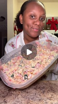 a woman holding a tray with food in it