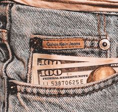 the back pocket of a pair of jeans with money sticking out of it's pockets