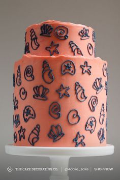 two tiered cake decorated with blue and pink icing