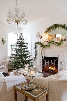 a living room filled with furniture and a christmas tree in front of a fire place