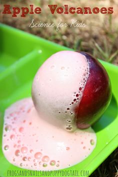 an apple sitting in a green container with liquid on it and the words apples volcanos science for kids