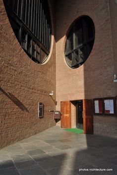 an outside view of a building with two round windows