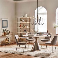 a dining room table with chairs and a chandelier