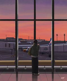 a person standing in front of an airport window