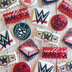 decorated cookies are arranged in the shape of wrestling rings and masks on a wooden surface